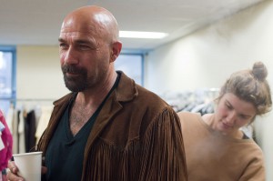 Costume designer steaming Kevin's suede fringe (production still)